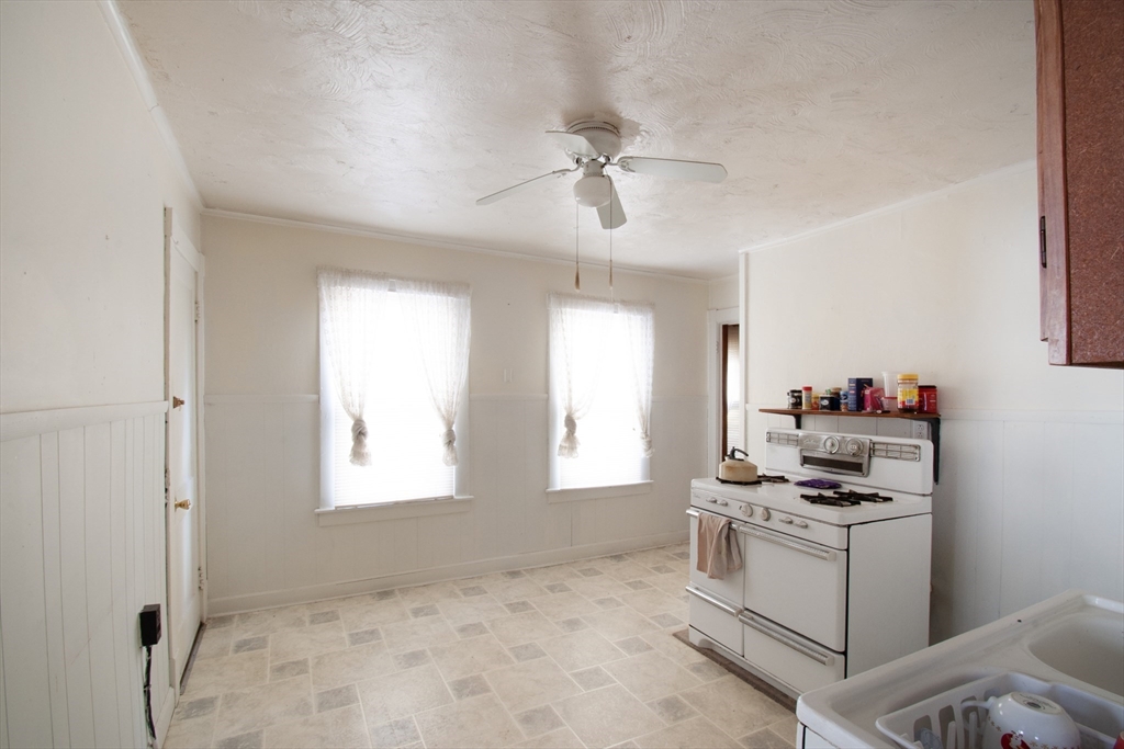 39-41 Malden Street Springfield, MA 01108 - Photo 3 of 27 a kitchen with a refrigerator stove and a window