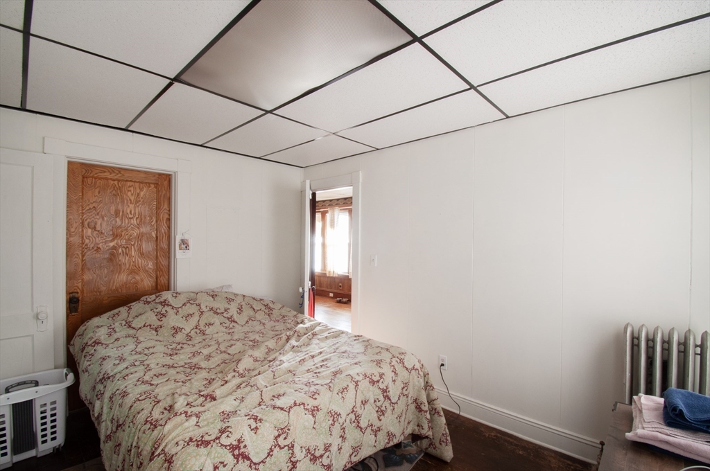 39-41 Malden Street Springfield, MA 01108 - Photo 8 of 27 a bedroom with a bed and a book shelf