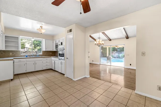 a kitchen with a sink a counter top space and appliances