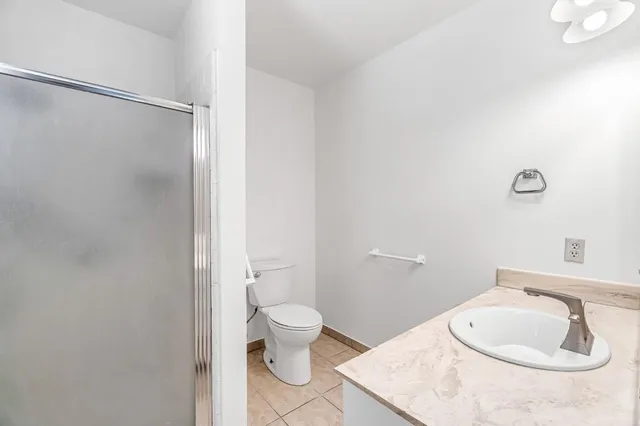 a view of a patio with a table and chairs under an umbrella
