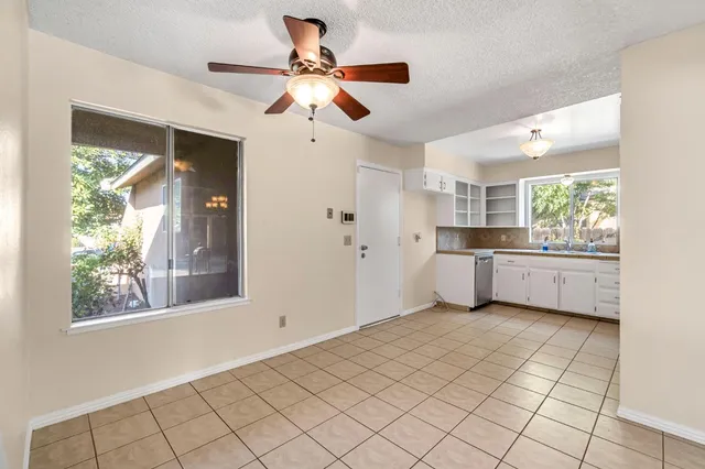 a view of a kitchen with a sink and windows