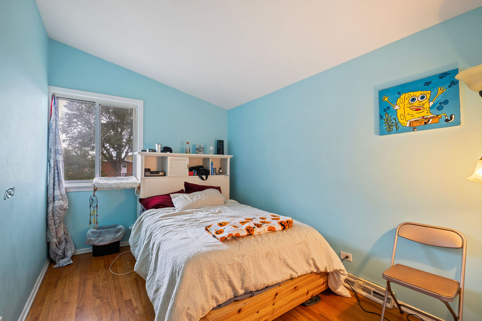 1578 Woodland Avenue, Unit D Des Plaines, IL 60016 - Photo 12 of 17 a bedroom with a bed and a lamp on dresser