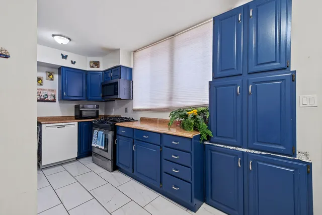 a kitchen with stainless steel appliances granite countertop wooden cabinets and a stove top oven