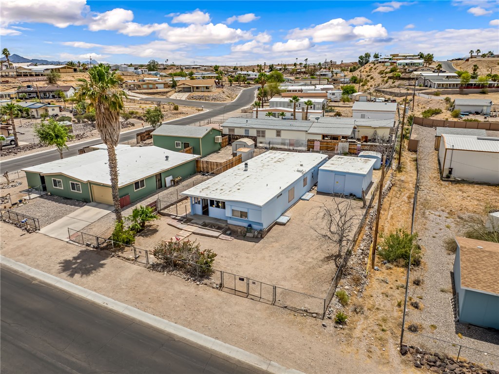 1666 Talc Road Bullhead City, AZ 86442 - Photo 1 of 61 Aerial overview highlighting two residential structures and outbuildings on a desert-landscaped lot