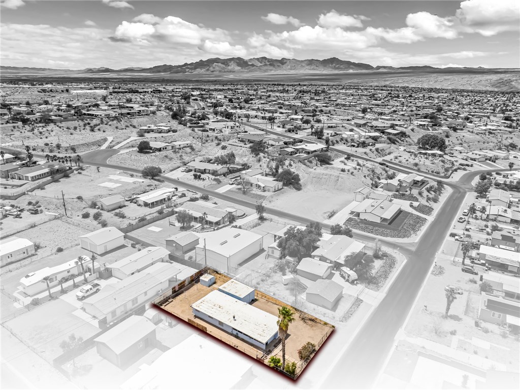 1666 Talc Road Bullhead City, AZ 86442 - Photo 2 of 61 Aerial perspective showcasing a property outlined in red, featuring a single-story structure with a flat roof