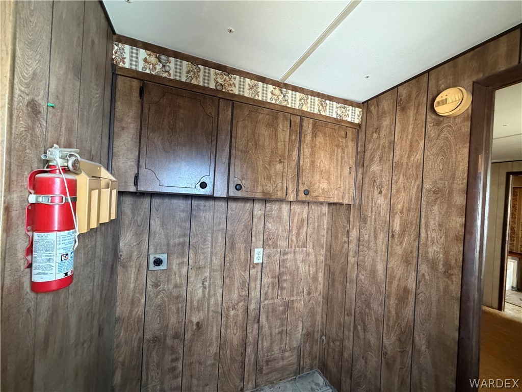 1666 Talc Road Bullhead City, AZ 86442 - Photo 35 of 61 Wood-panel walls featuring built-in cabinetry and overhead trim
