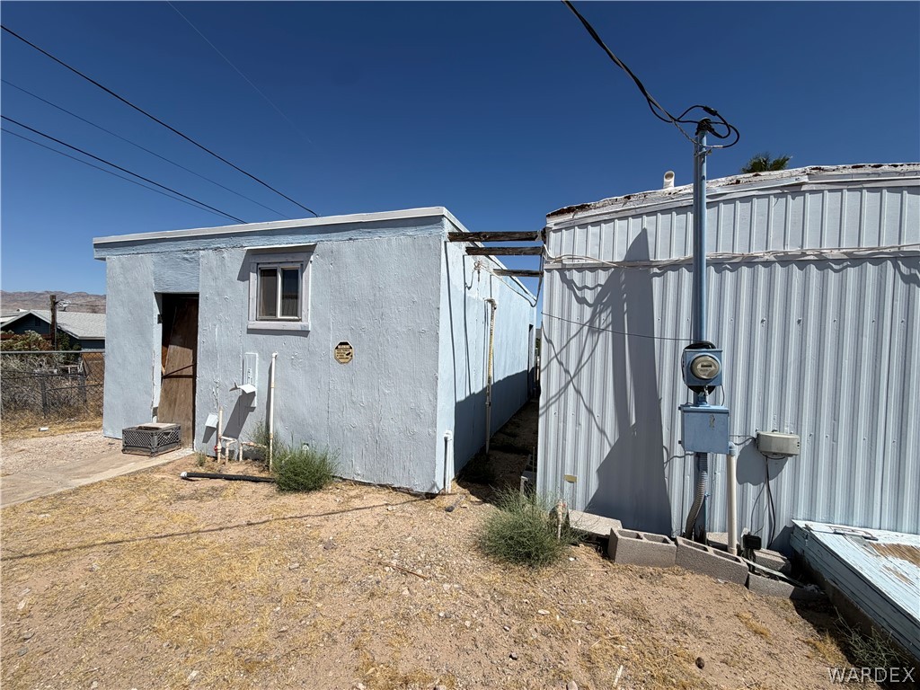 1666 Talc Road Bullhead City, AZ 86442 - Photo 37 of 61 Light blue stucco exterior with a single window