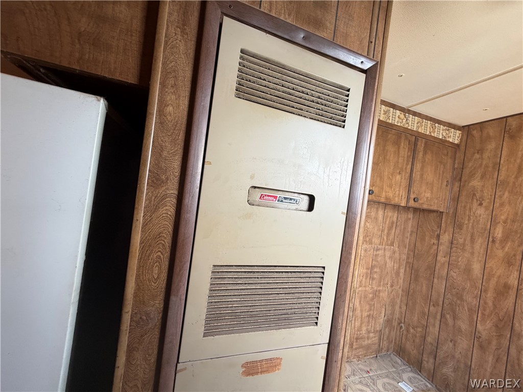 1666 Talc Road Bullhead City, AZ 86442 - Photo 43 of 61 Built-in wall heater with louvered vents, framed by wood-finish trim