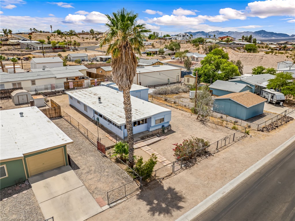 1666 Talc Road Bullhead City, AZ 86442 - Photo 47 of 61 Single-story residence with a light-colored exterior and a prominent palm tree