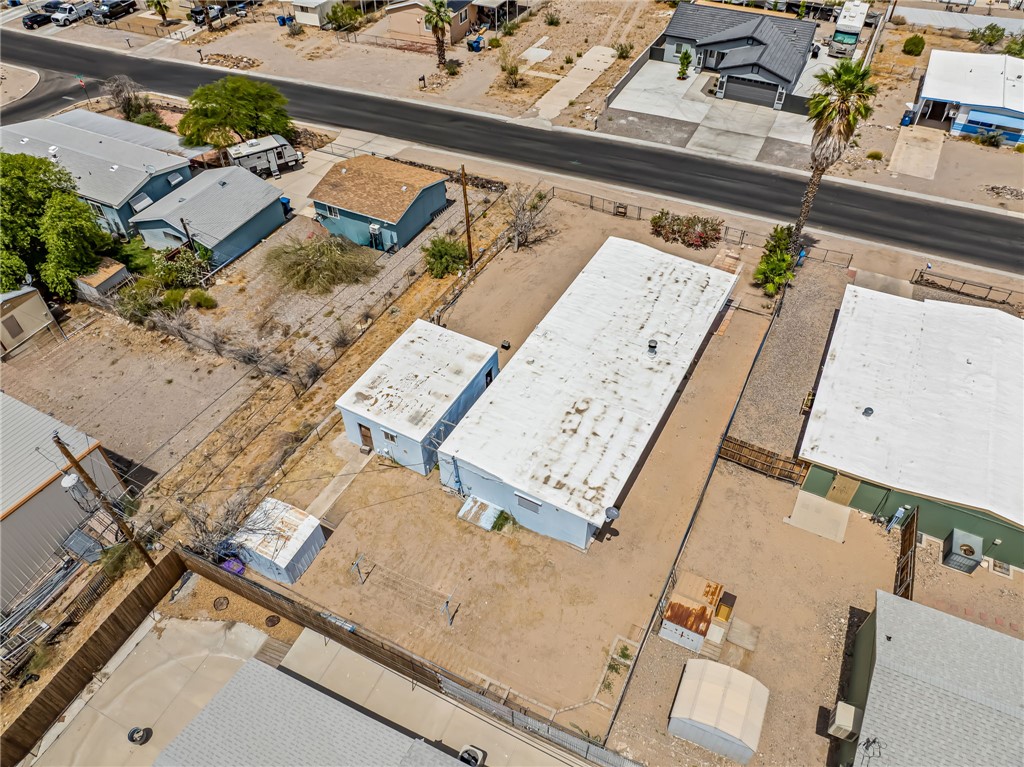 1666 Talc Road Bullhead City, AZ 86442 - Photo 51 of 61 Aerial perspective showcasing a light-colored property with multiple outbuildings