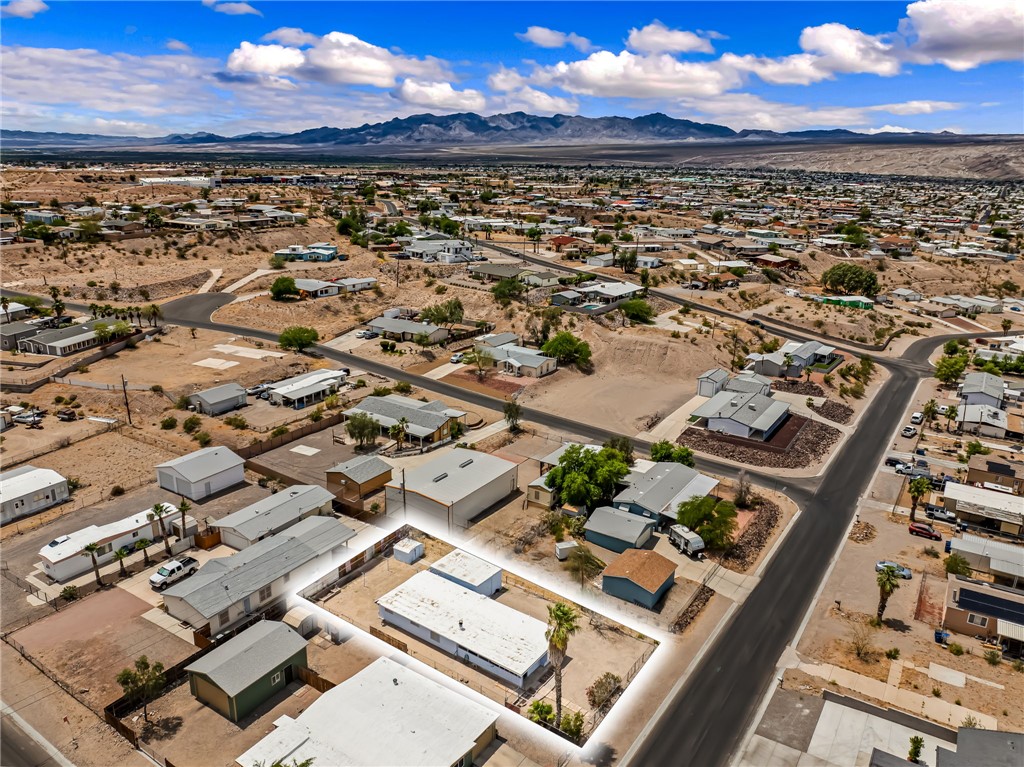 1666 Talc Road Bullhead City, AZ 86442 - Photo 58 of 61 Aerial perspective showcasing a residential area with varied housing structures, paved streets, and mountainous terrain in the background