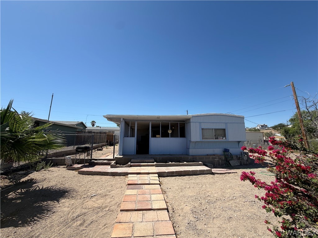 1666 Talc Road Bullhead City, AZ 86442 - Photo 5 of 61 Light blue siding exterior with a covered porch