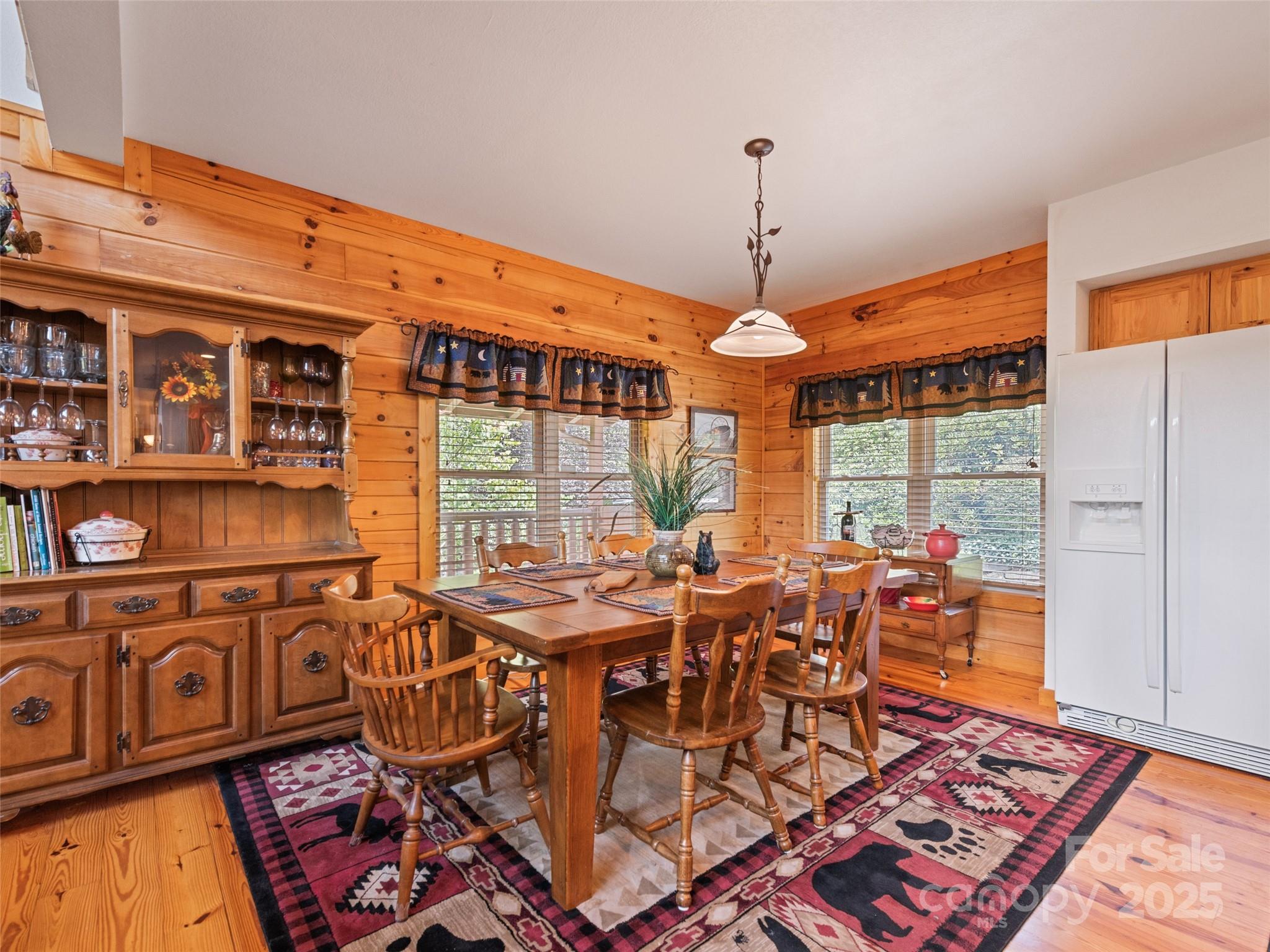 432 Raccoon Point Waynesville, NC 28786 - Photo 11 of 48 a view of a dining room with furniture window and wooden floor