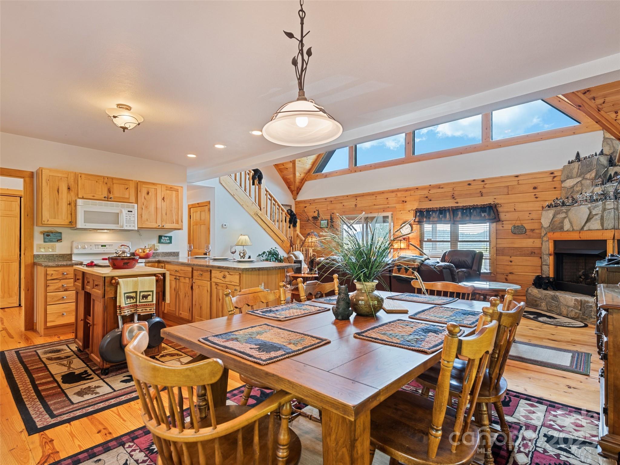 432 Raccoon Point Waynesville, NC 28786 - Photo 12 of 48 a view of a dining room with furniture window and wooden floor