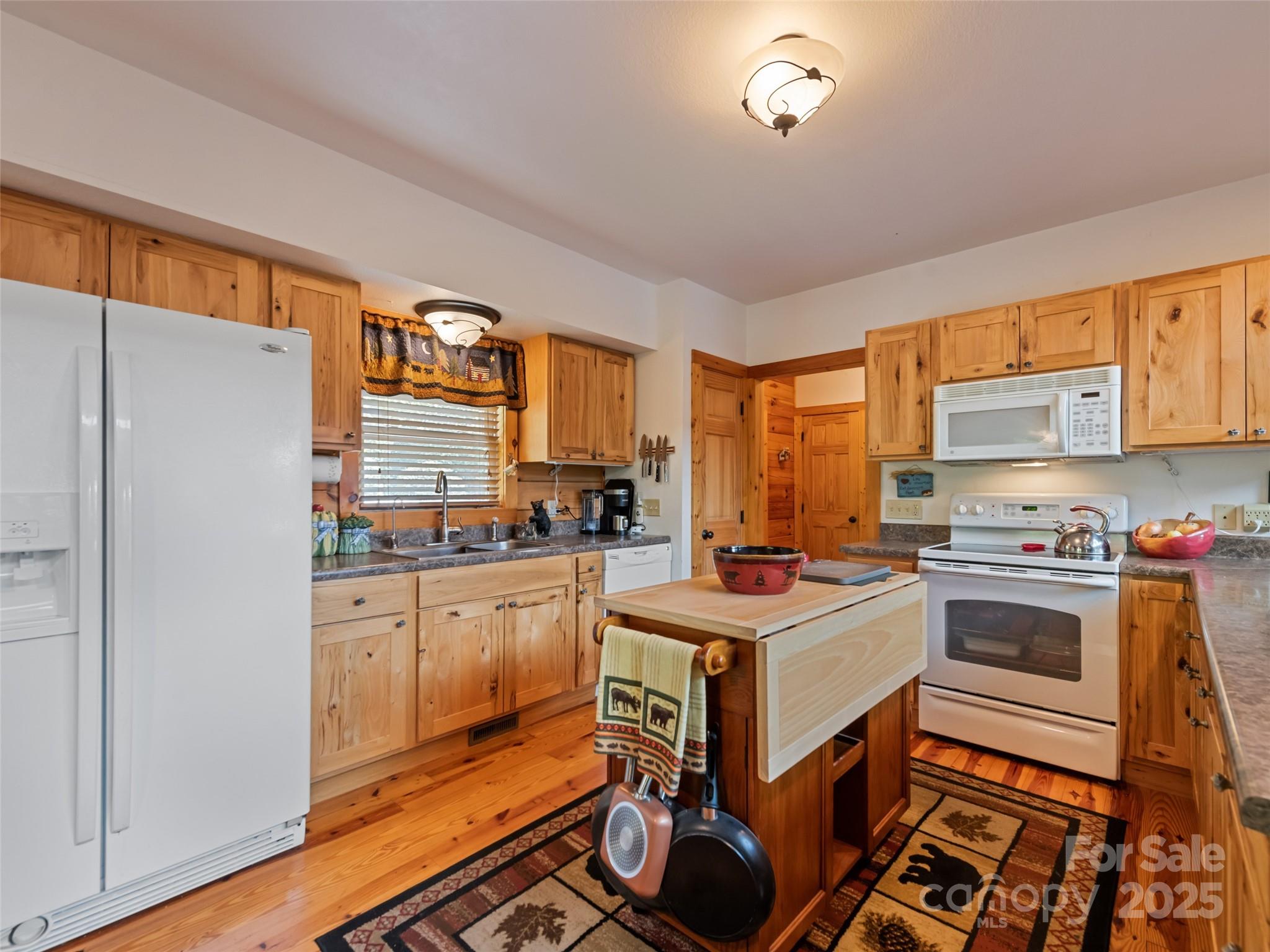 432 Raccoon Point Waynesville, NC 28786 - Photo 14 of 48 a kitchen with a stove a refrigerator and a stove top oven