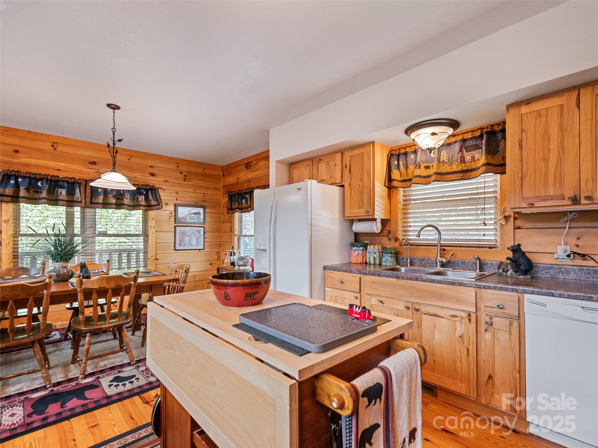 432 Raccoon Point Waynesville, NC 28786 - Photo 16 of 48 a kitchen with stainless steel appliances granite countertop a stove a sink dishwasher and a dining table with chairs