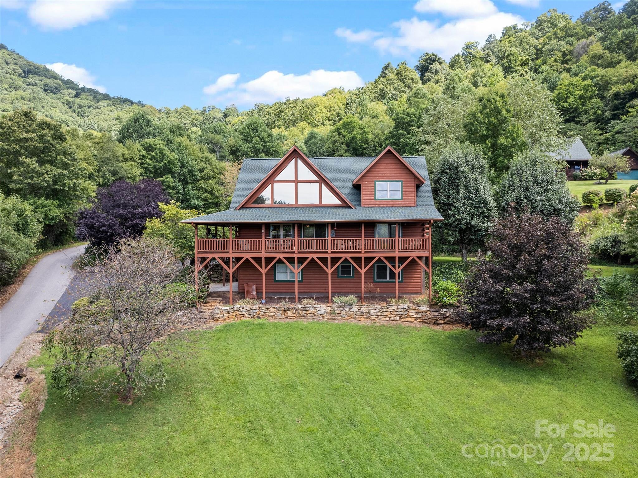 432 Raccoon Point Waynesville, NC 28786 - Photo 2 of 48 a wooden house with swimming pool in front of it