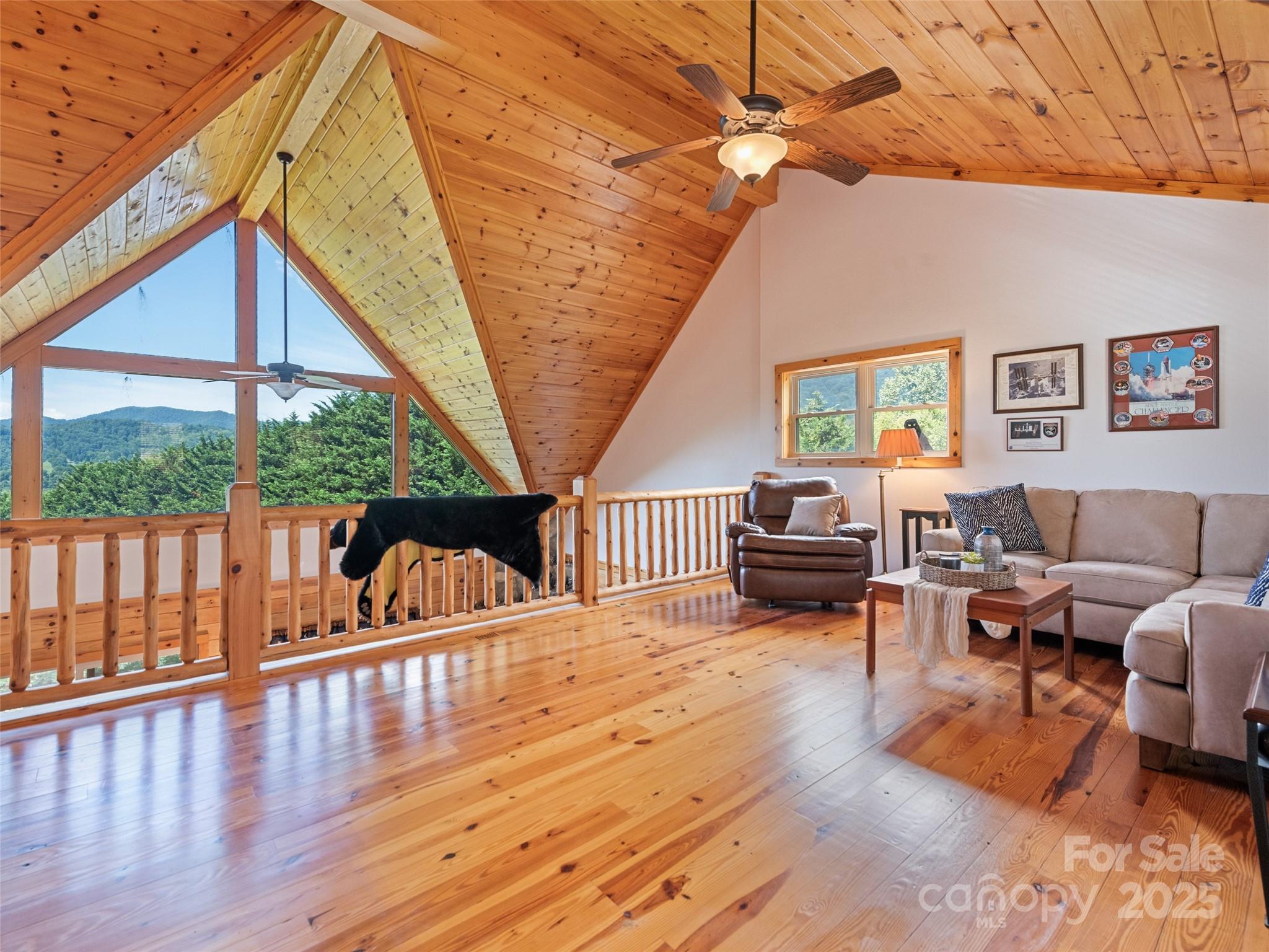 432 Raccoon Point Waynesville, NC 28786 - Photo 23 of 48 a living room with furniture a wooden floor and next to a window