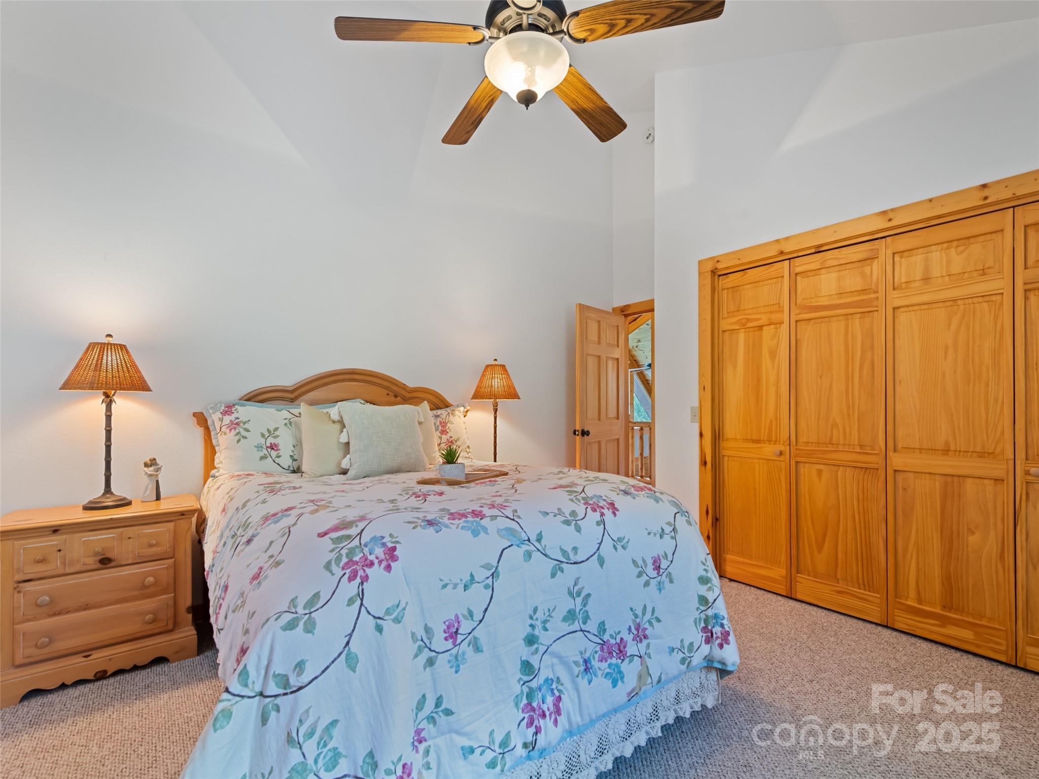 432 Raccoon Point Waynesville, NC 28786 - Photo 30 of 48 a bedroom with a bed and a chandelier