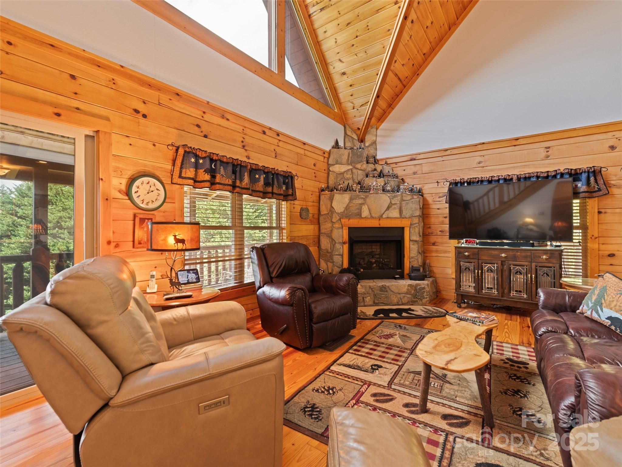 432 Raccoon Point Waynesville, NC 28786 - Photo 10 of 48 a living room with furniture a flat screen tv and a chandelier