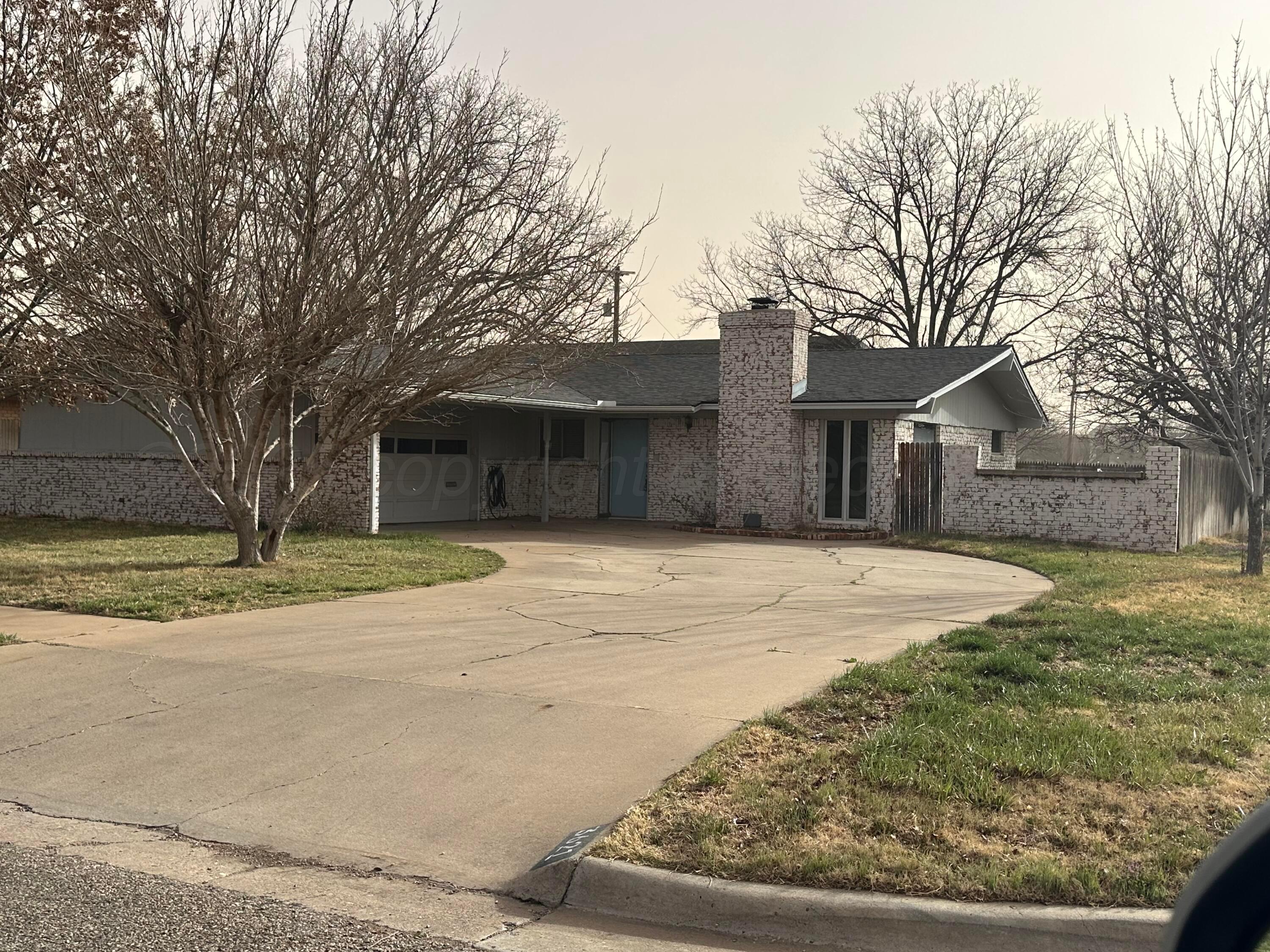 3621 Thurman Street Amarillo, TX 79109 - Photo 1 of 13 a house with trees in front of it