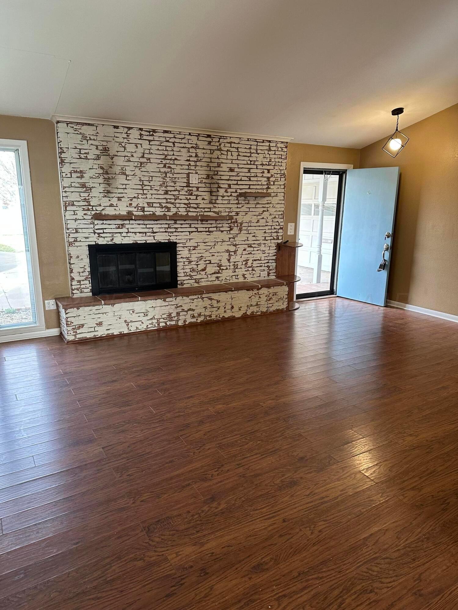 3621 Thurman Street Amarillo, TX 79109 - Photo 3 of 13 a view of a livingroom with wooden floor and a fireplace