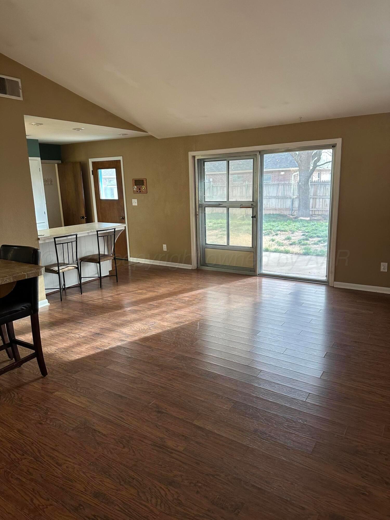 3621 Thurman Street Amarillo, TX 79109 - Photo 4 of 13 a view of empty room with wooden floor and fan