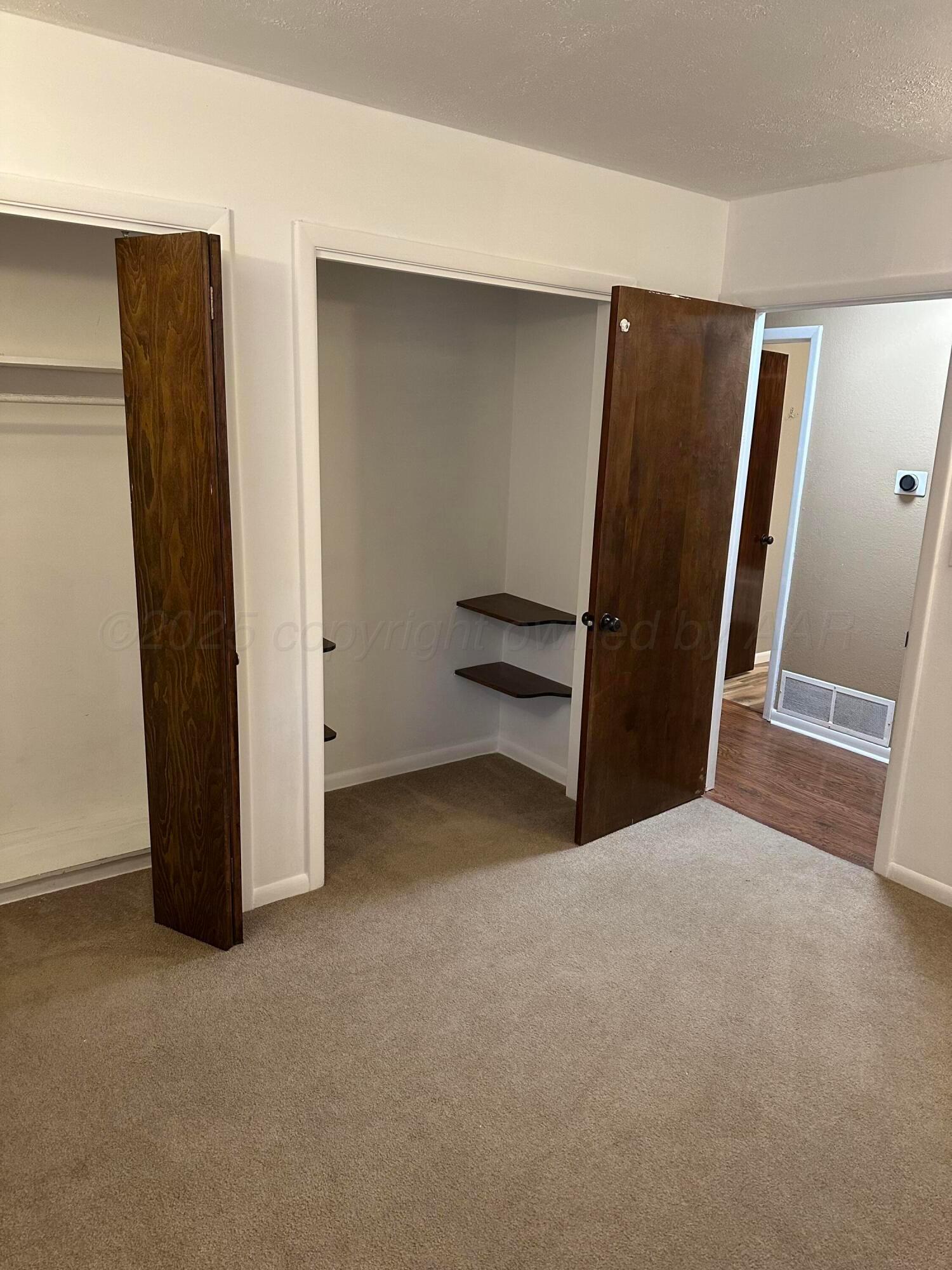 3621 Thurman Street Amarillo, TX 79109 - Photo 8 of 13 an empty room with closet and a refrigerator