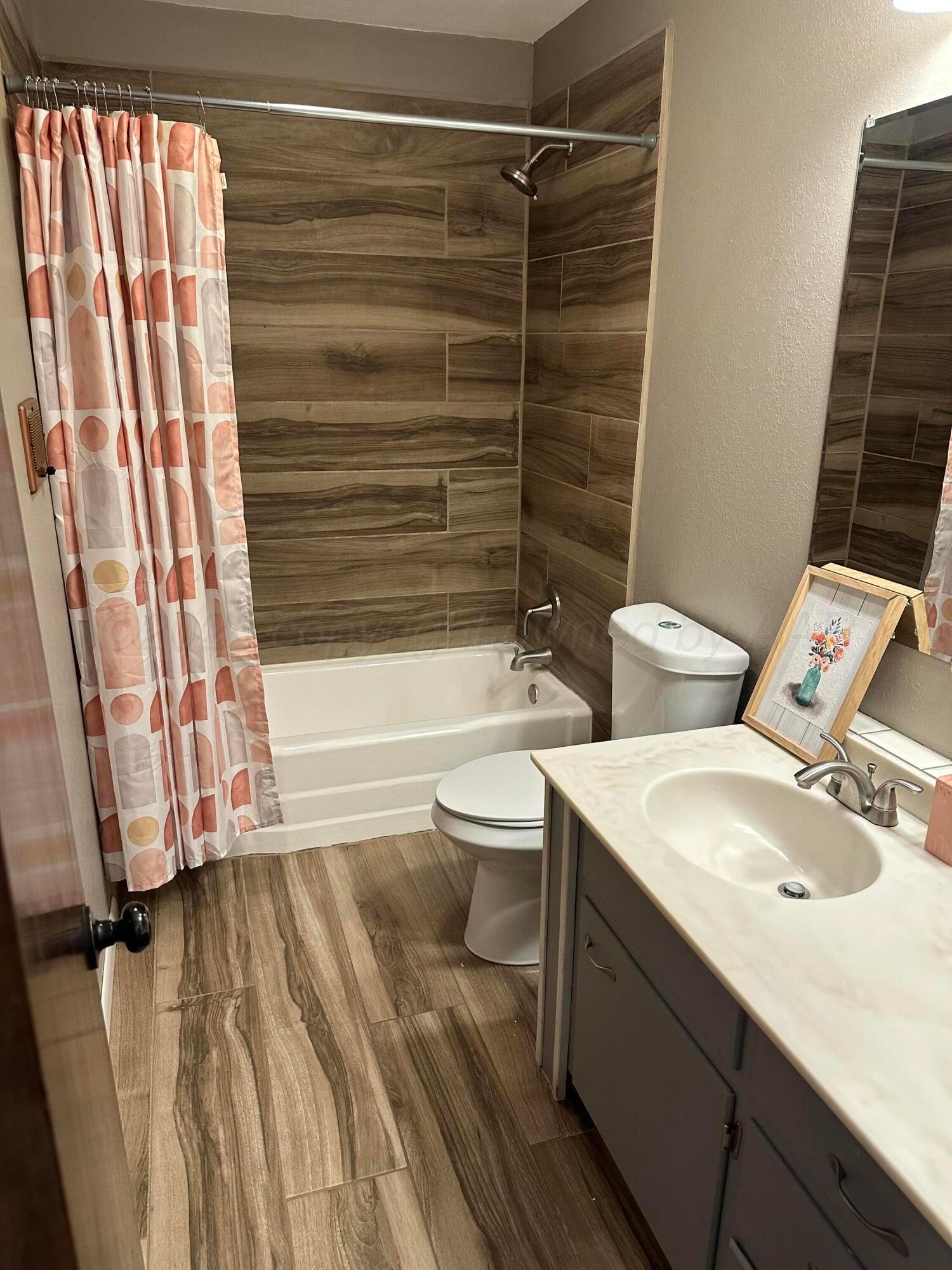 3621 Thurman Street Amarillo, TX 79109 - Photo 9 of 13 a bathroom with a sink toilet and shower