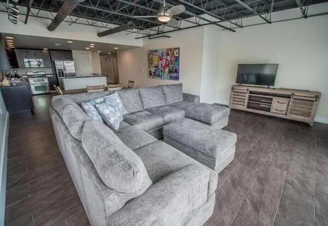 a living room with furniture and a flat screen tv