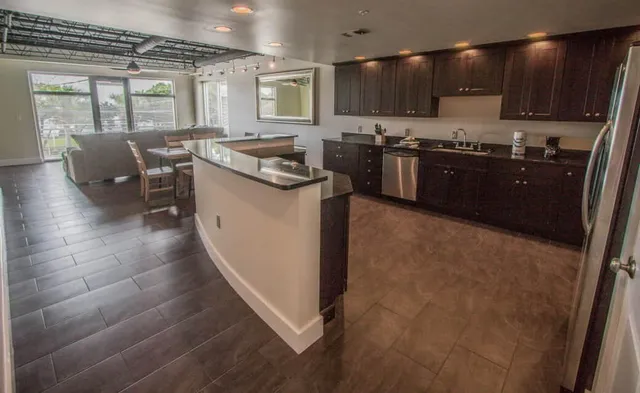 a kitchen with stainless steel appliances granite countertop a sink stove and cabinets
