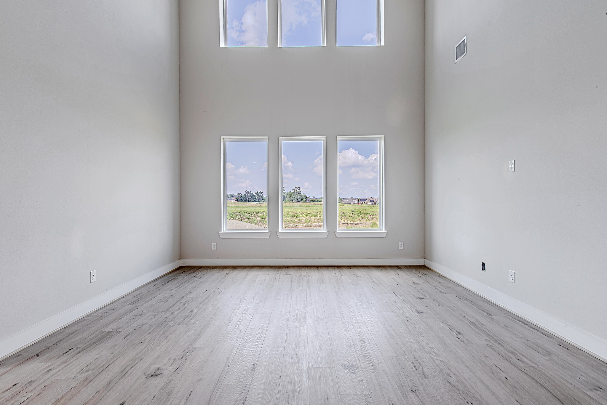 177 Peninsula Point Drive Montgomery, TX 77356 - Photo 11 of 40 Dramatic two-story living room boasts a full wall of windows, bathing the space in natural light and offering unobstructed views of the outdoors.