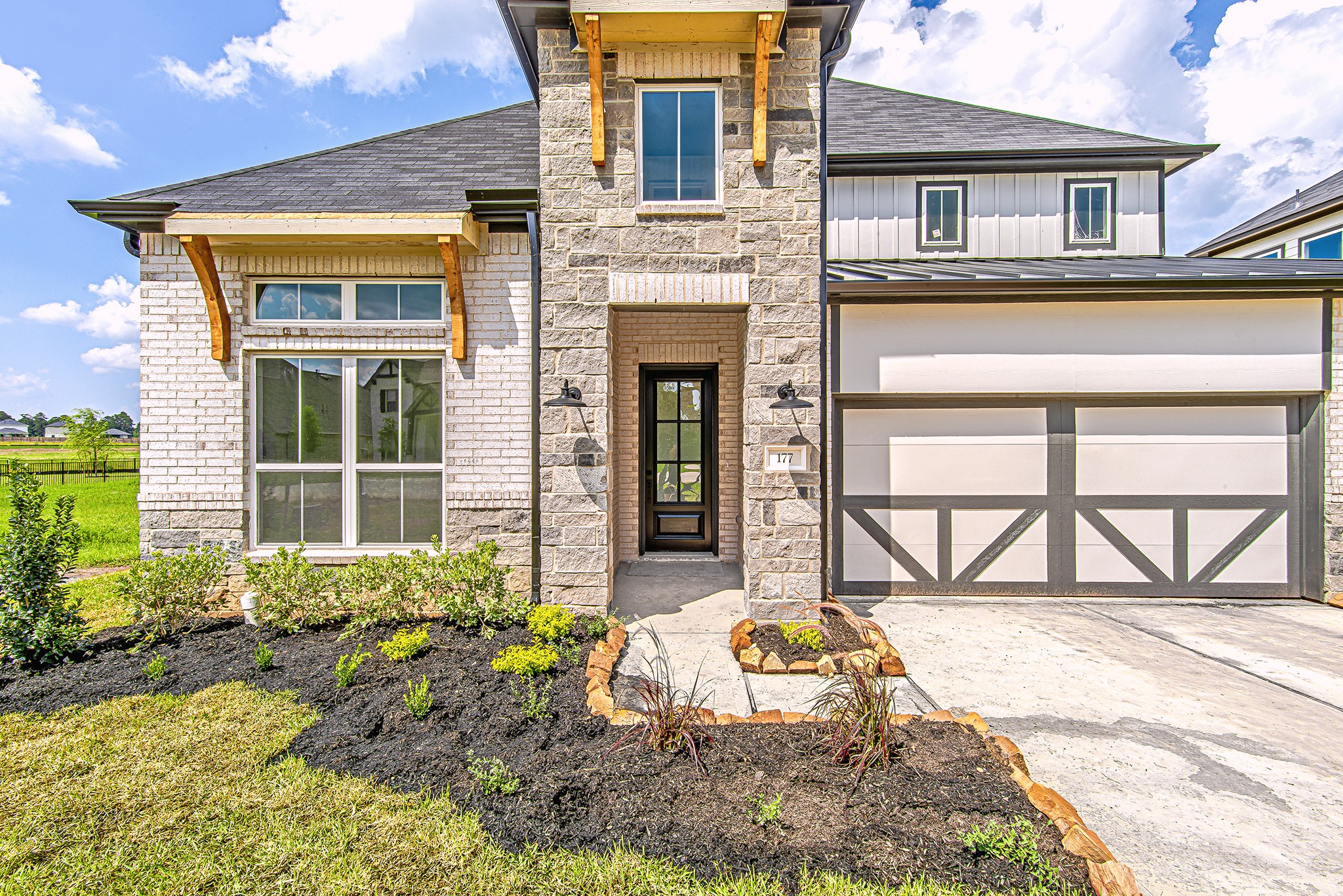 177 Peninsula Point Drive Montgomery, TX 77356 - Photo 5 of 40 A welcoming front entryway framed by stone columns and custom wood corbels creates a bold yet inviting first impression.