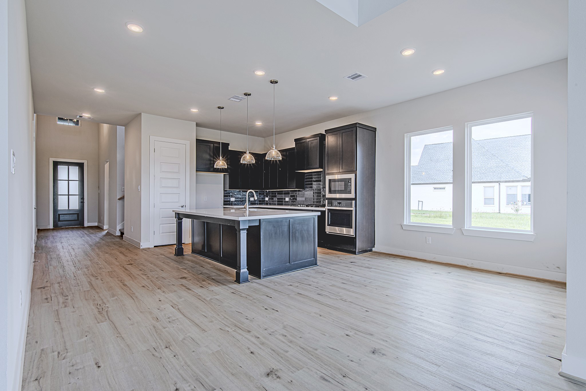 177 Peninsula Point Drive Montgomery, TX 77356 - Photo 8 of 40 This stunning open-concept kitchen is the heart of the home, featuring an oversized island, designer lighting, and seamless flow into the living and dining areas.