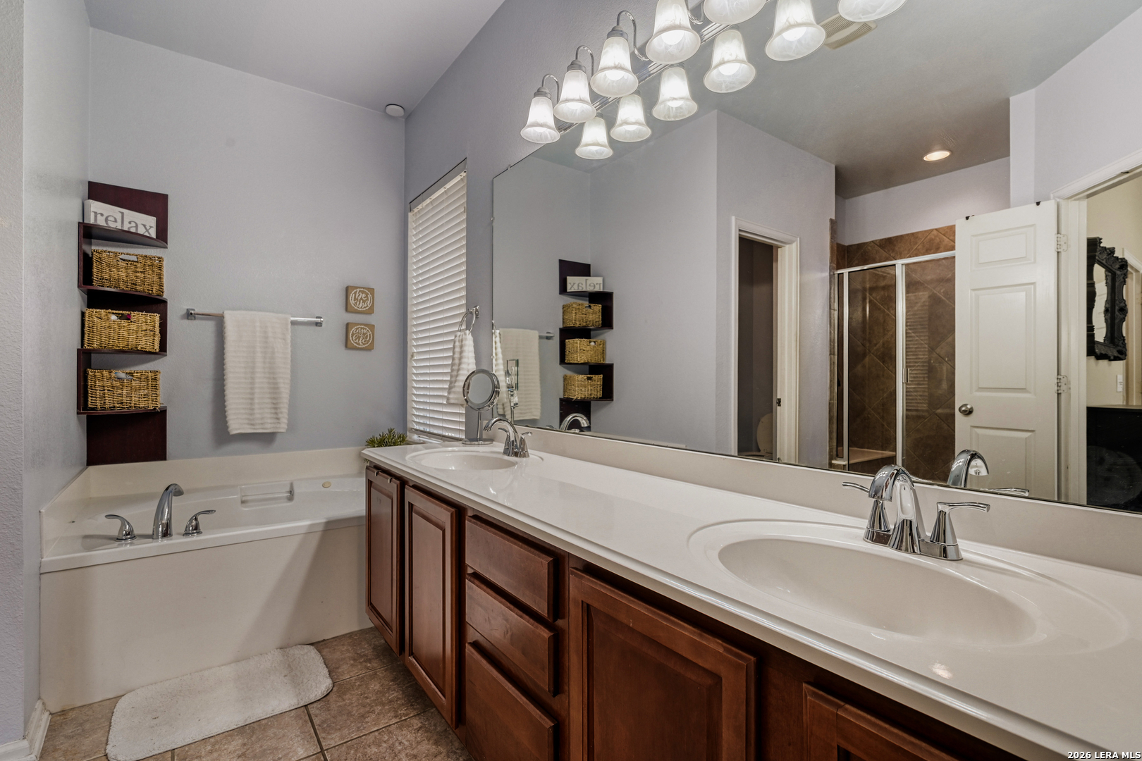 10539 Rainbow View Helotes, TX 78023 - Photo 13 of 24 a bathroom with a tub double sink and mirror