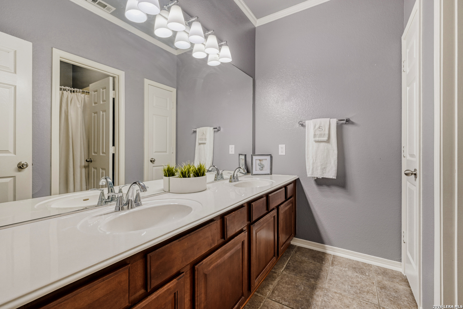 10539 Rainbow View Helotes, TX 78023 - Photo 18 of 24 a bathroom with a double vanity sink and a mirror