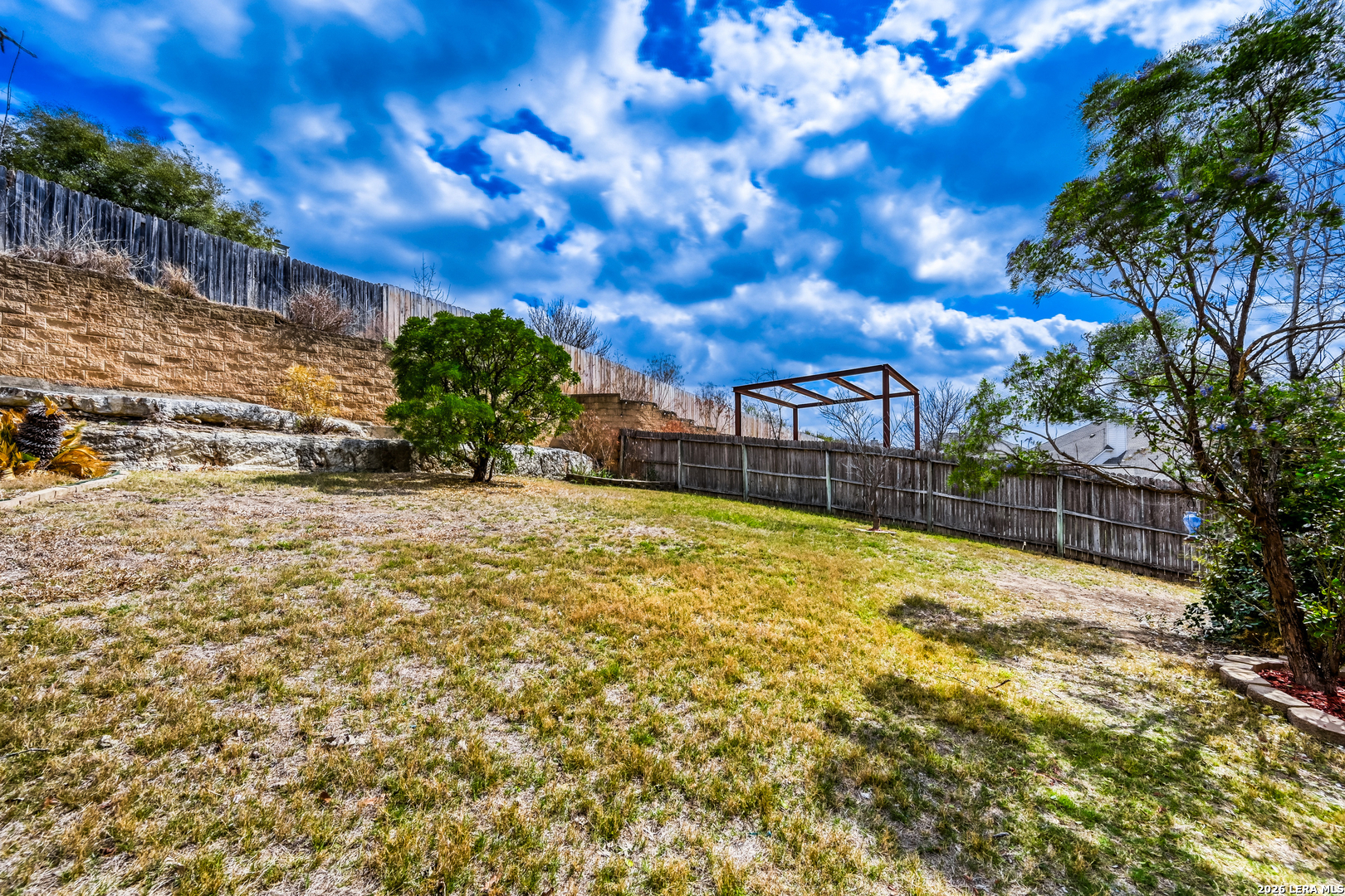 10539 Rainbow View Helotes, TX 78023 - Photo 24 of 24 a view of swimming pool with patio and yard