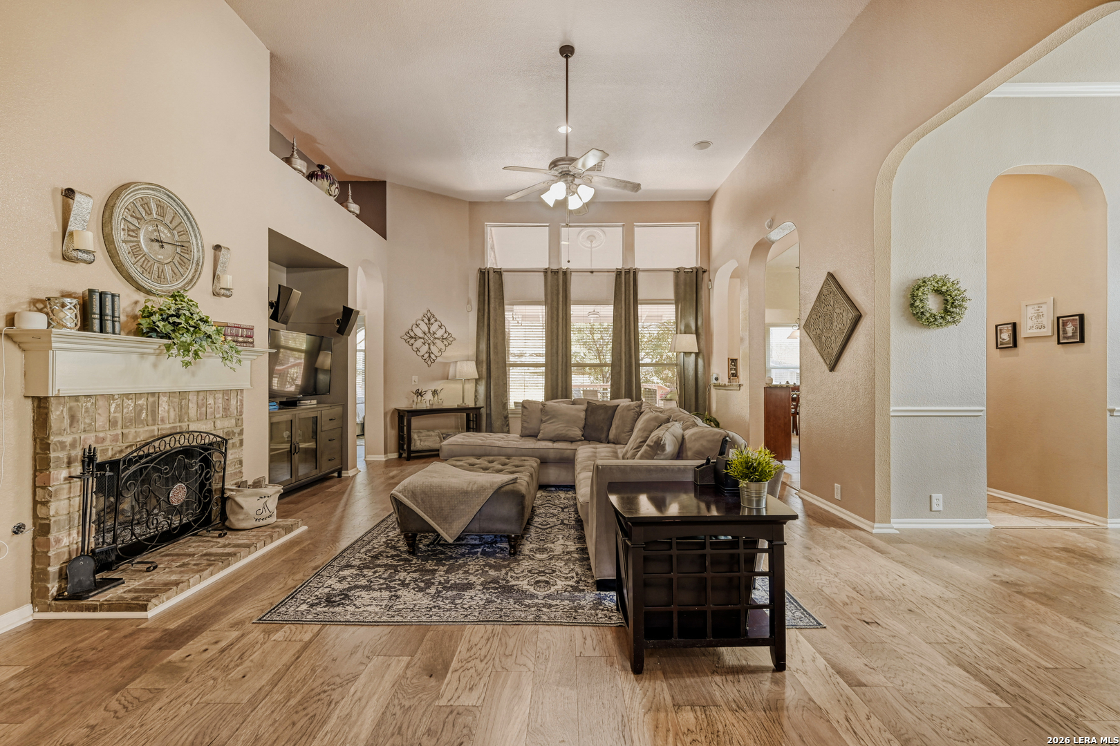 10539 Rainbow View Helotes, TX 78023 - Photo 3 of 24 a living room with furniture a fireplace and a chandelier
