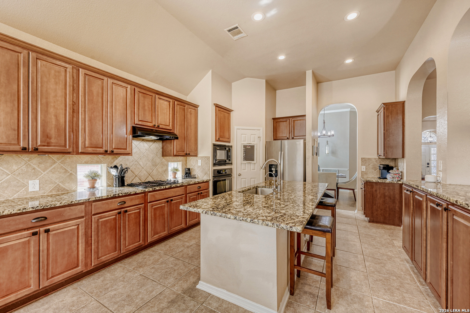 10539 Rainbow View Helotes, TX 78023 - Photo 9 of 24 a kitchen with stainless steel appliances granite countertop a sink and cabinets