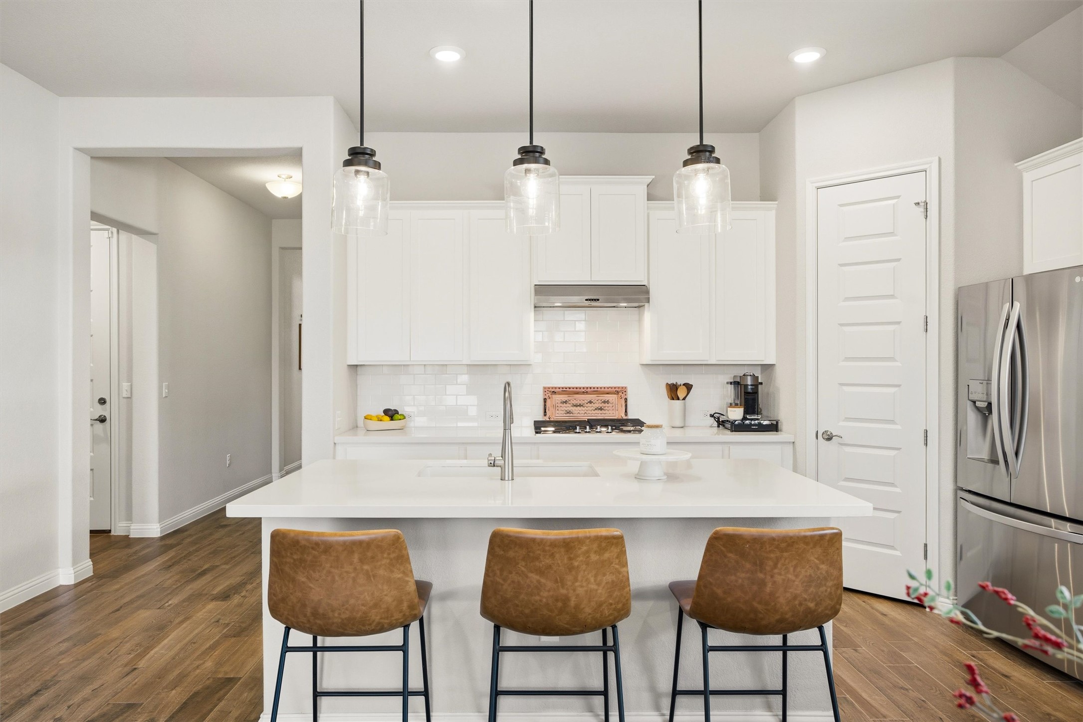 7905 Corrigan Pass Austin, TX 78744 - Photo 7 of 36 A large center island with breakfast bar seating creates the perfect gathering spot.