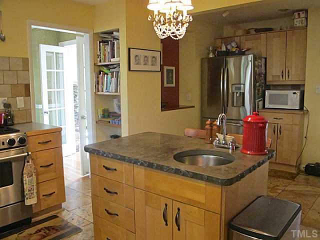 1919 Highland Place Raleigh, NC 27607 - Photo 11 of 19 a kitchen with stainless steel appliances granite countertop a sink stove and refrigerator