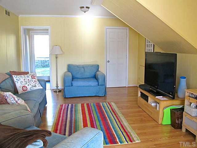 1919 Highland Place Raleigh, NC 27607 - Photo 16 of 19 a living room with furniture and a flat screen tv