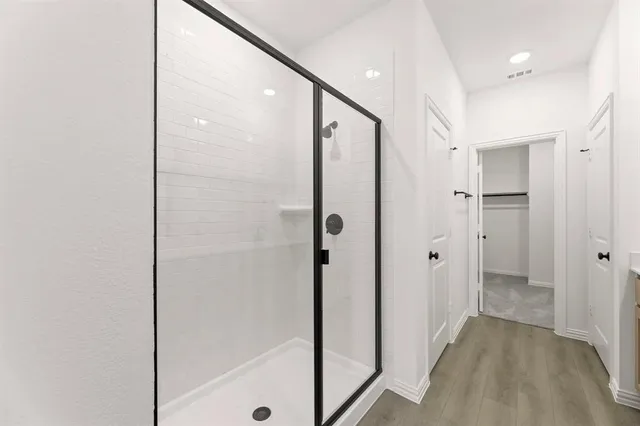 a bathroom with a glass shower door