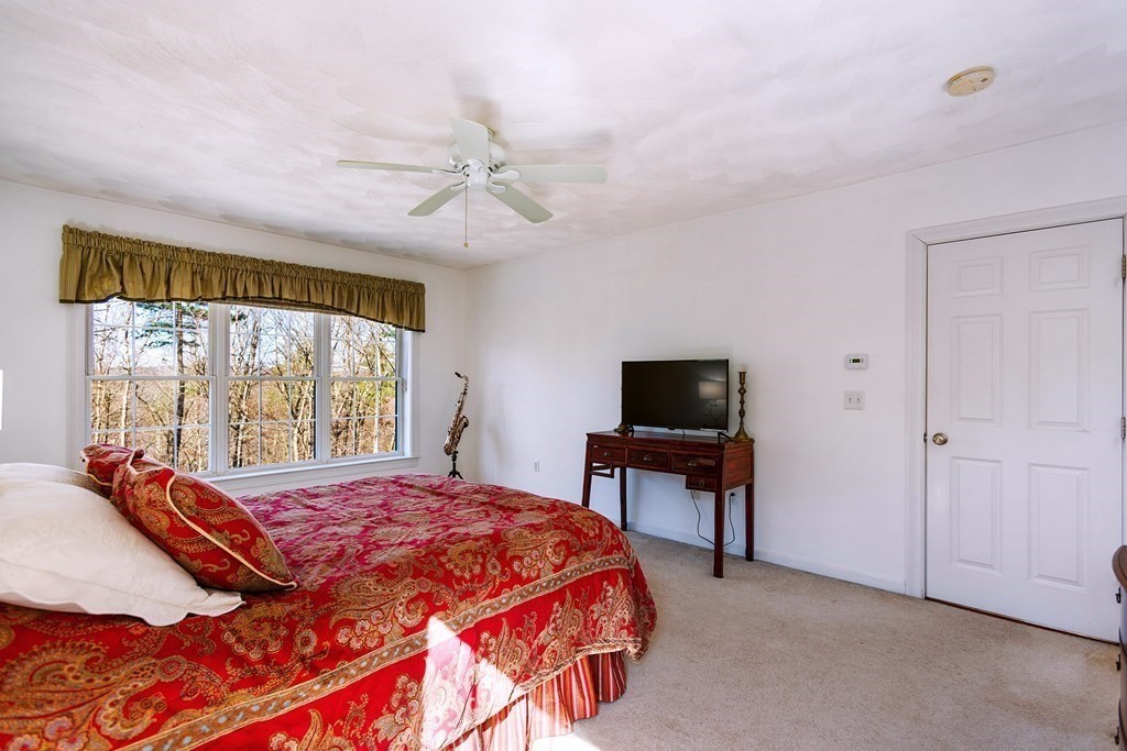 95 Lunenburg Road Townsend, MA 01474 - Photo 16 of 42 a bedroom with a bed and a flat screen tv