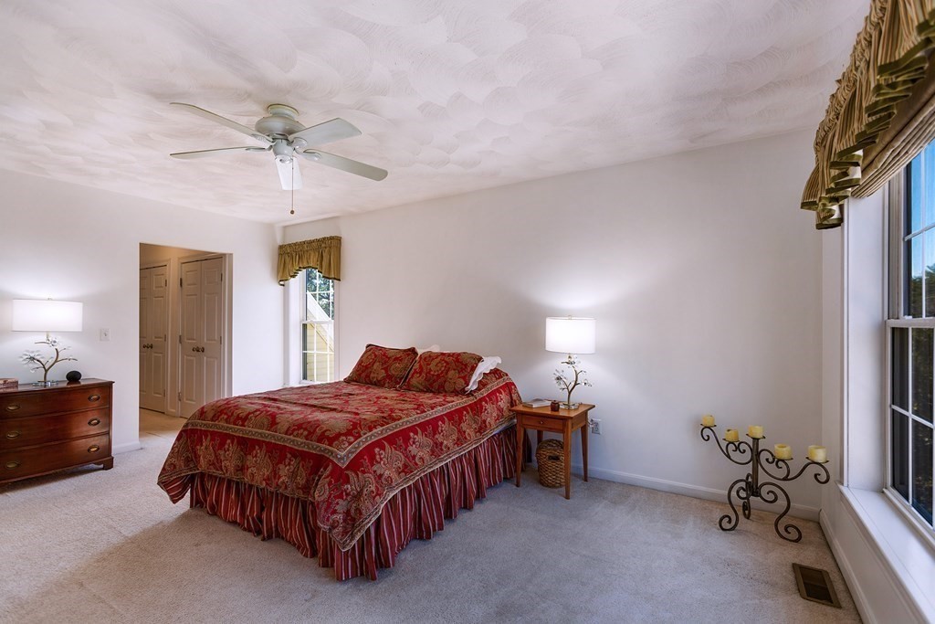 95 Lunenburg Road Townsend, MA 01474 - Photo 18 of 42 a bedroom with a bed and a chandelier