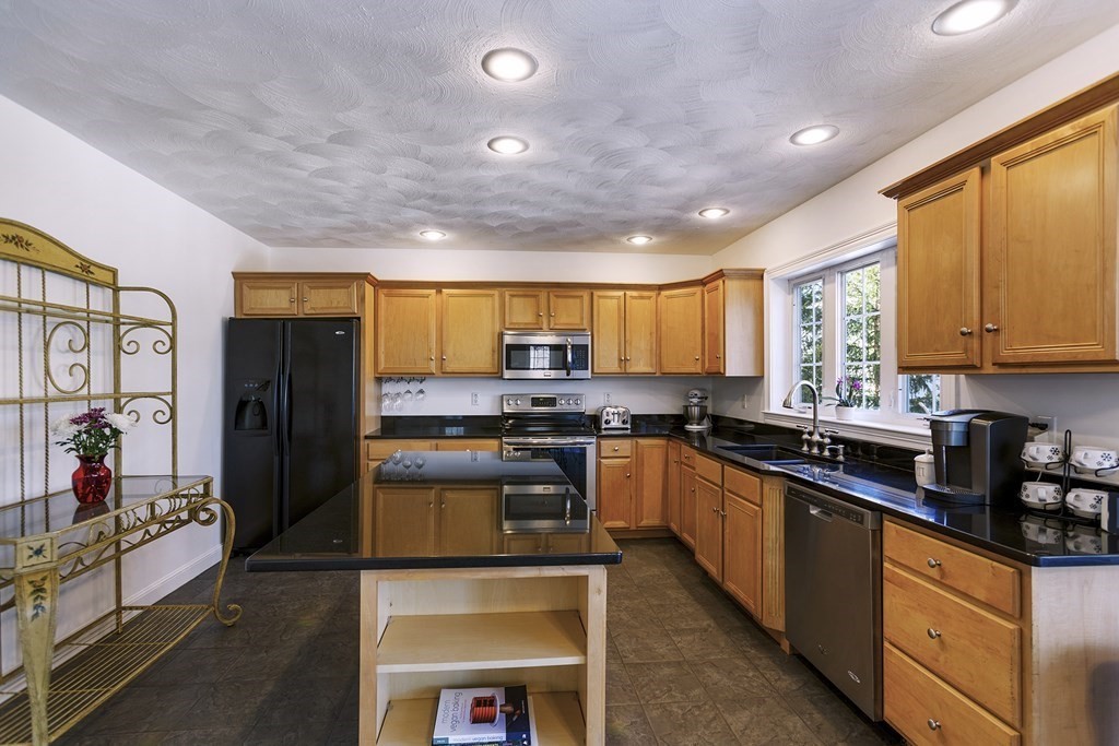 95 Lunenburg Road Townsend, MA 01474 - Photo 6 of 42 a kitchen with stainless steel appliances granite countertop sink stove refrigerator and cabinets