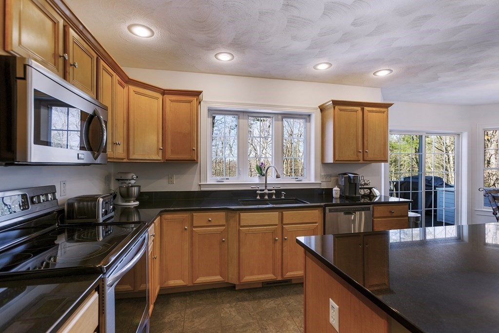 95 Lunenburg Road Townsend, MA 01474 - Photo 7 of 42 a kitchen with lots of counter top space a sink and appliances
