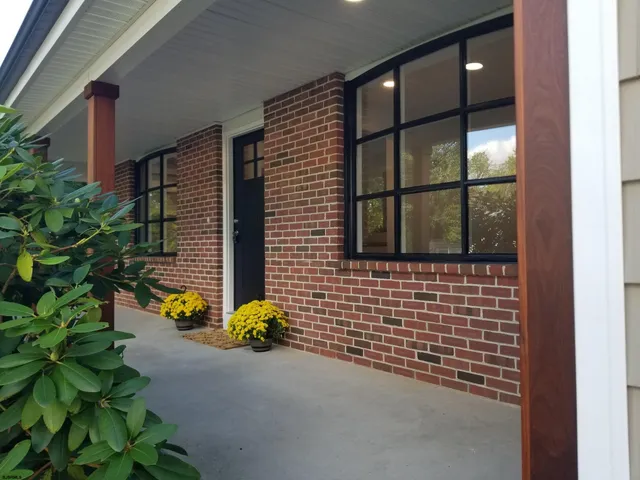a front view of a house with a garden