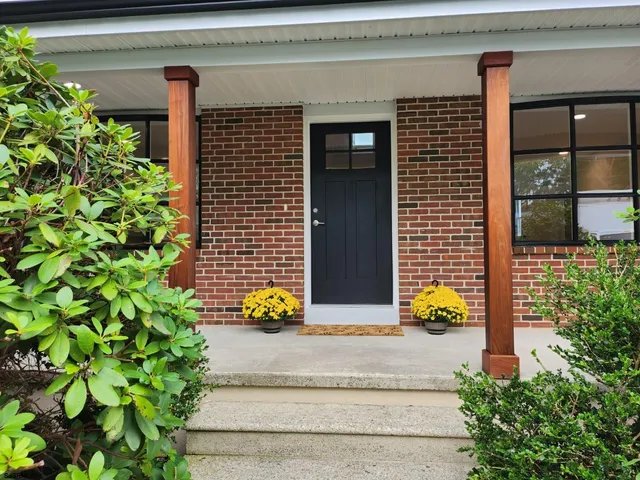 a kitchen with granite countertop a stove fireplace and a wooden floor
