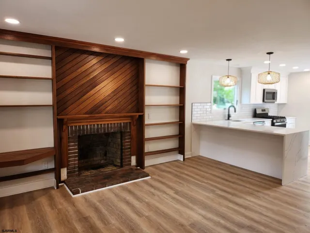 a view of kitchen and hall with wooden floor